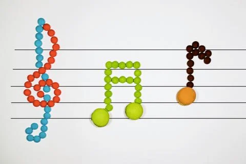 Musical notes with macarons Stock Photos