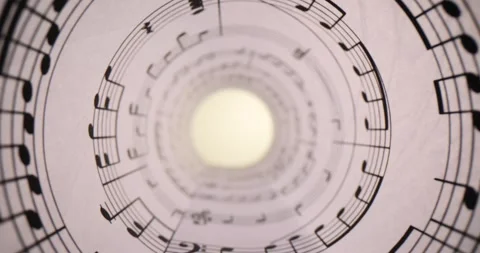 Musical notes printed on a sheet of paper rolled into a tube Stock Footage 267027493