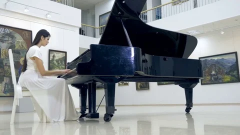 Musical pianist playing classical grand piano in a center of concert hall Stock Footage