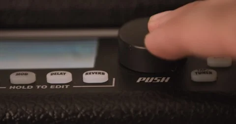 Musician Adjusting Knobs On Guitar Solid State Amp. Dolly Shot. Video stock 114642930