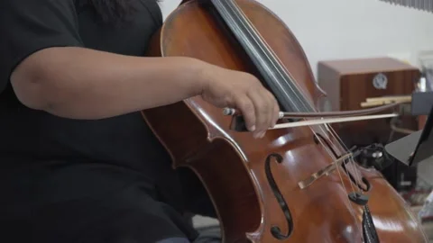 Musician cellist playing the cello while she is practicing Video stock 172424463