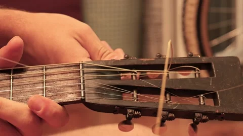 Musician changing broken string on acoustic guitar Stock Footage 341376535