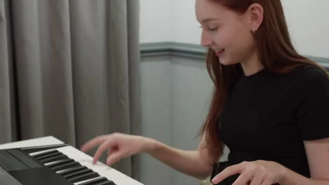 Musician composing electronic music using midi controller keyboard Stock Footage 301274462