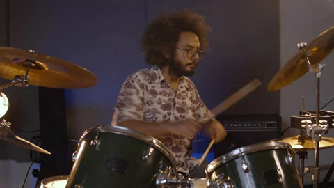 Musician. Creative process. Afro man playing drums in the rehearsal space Stock Footage 139896926