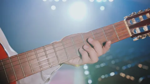 Musician Fingers Squeezing Strings on Guitar Neck During Live Performance 動画素材 337702819