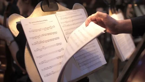 The musician flips through the notes Stock Footage 154910659