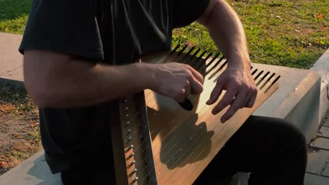 Musician hands beat the strings rhythmically. Man holds gusli. Close-up. Stock Footage 169051596