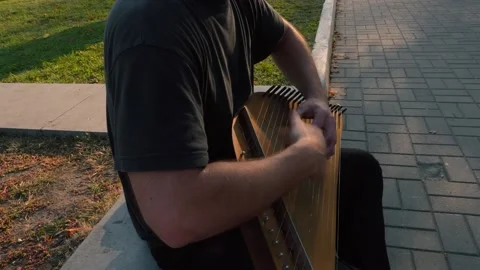 Musician hands beat the strings rhythmically. Man holds gusli. Close-up. Stock Footage 169051639