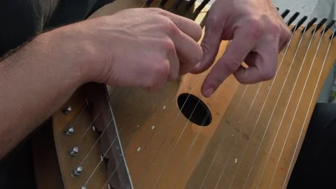 Musician hands beat the strings rhythmically. Man holds gusli. Close-up. Stock Footage 169051669