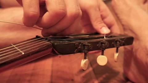 Musician hands changing classical guitar strings Stock Footage 341376520