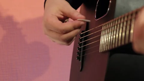 Musician navigates guitar strings with precision in studio Stock Footage 307037091