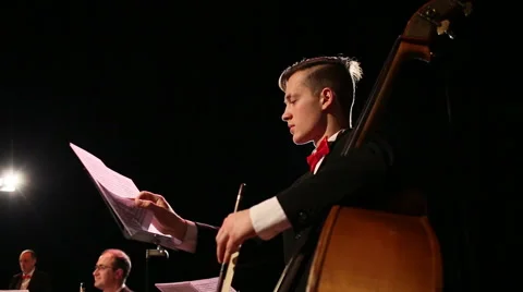 Musician in orchestra leafing through notes Stock Footage 45174636