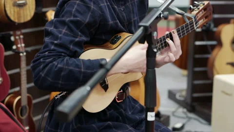The musician performs on a four-string ukulele. Stock Footage 164045832
