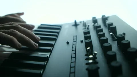 Musician playing and tweaking knobs on analog synthesizer Video stock 311943193