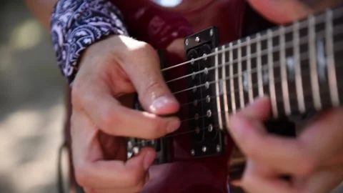 Musician playing electric guitar at an acoustic outdoor concert Stock Footage