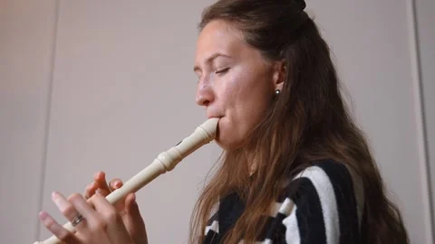 Musician playing recorder flute in split screen montage Stock Footage 299752378