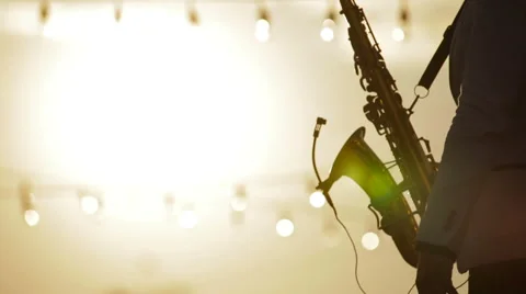 The musician playing the saxophone at sunset2 Stock Footage