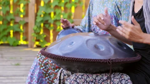 Musician plays the glucophone. Closeup of hands of girl playing on tank drum Stock Footage 153068053