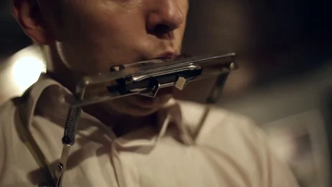 Musician plays the harmonica Stock Footage 69869752