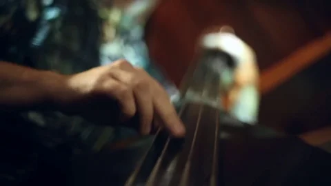 The musician plays jazz music on the cello Stock Footage