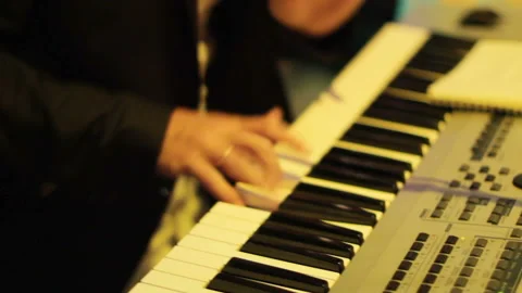 The musician plays keyboards while performing Stock-Footage 114961287