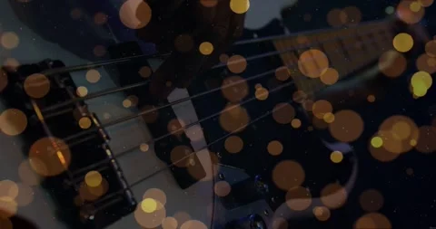 Musician plucking bass strings while recording music, warm bokeh overlay Stock Footage 334316273