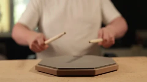 Musician practicing drumming on a practice pad with drumsticks Vidéo 341737660