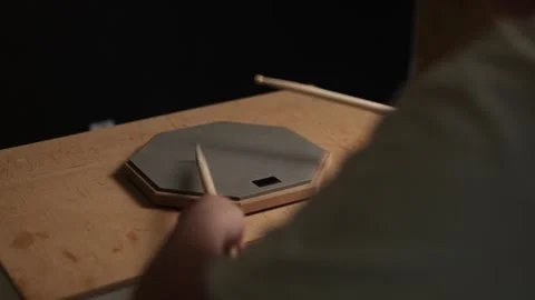 Musician practicing drumming on a practice pad with drumsticks Vidéo 341737813