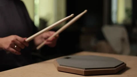 Musician practicing drumming on a practice pad with sticks Vidéo 341737852