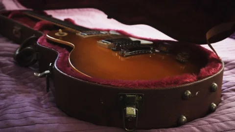 Musician is preparing for performance. Man opening a guitar leather case Stock Footage 104366367