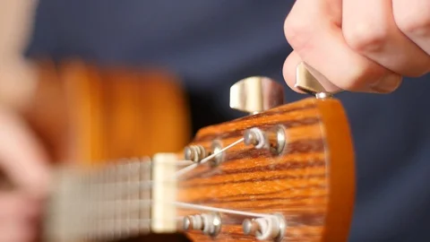 Musician Tuning Chords Of His Instrument Closeup Stock Footage