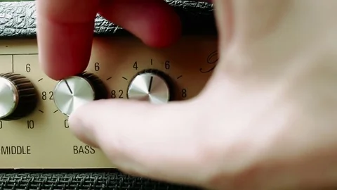 Musician turning the control knobs on a guitar amp 스톡 동영상 72222039