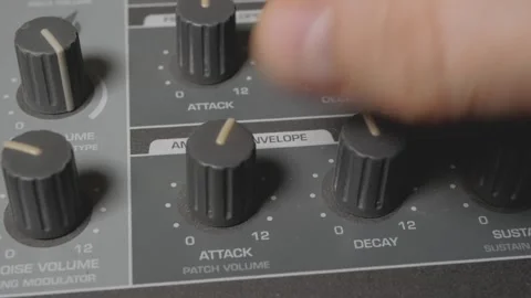 A musician turns the knobs of a synthesizer to adjust the sound. 스톡 동영상 305091463