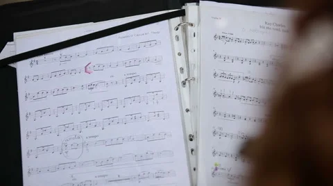 Musician turns the notes to find a suitable composition Stock Footage 41290812