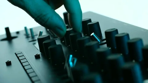 Musician tweaking knobs on analog synthesizer Video stock 311939938