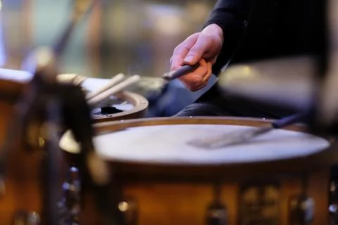 The musician's hand during performance of a composition on a drum set Foto stock