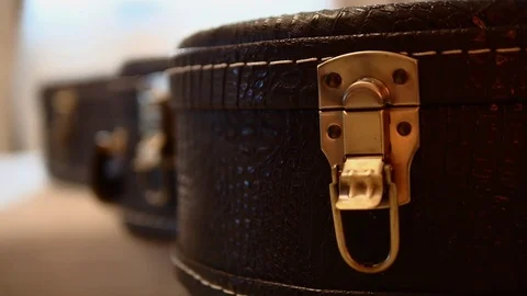 A musician's hand is unlocking a guitar case. Stock Footage 114032755