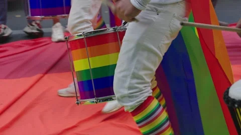 Musicians playing drums having fun and celebration in pride parade. Rainbow drum Stock-Footage 243048930