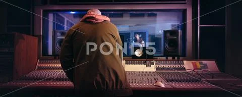 Musicians producing music in professional recording studio Stock Photos