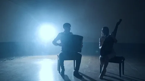 Musicians silhouettes playing and falling sheets, smoke on background in slowmo Stock Footage 106698525