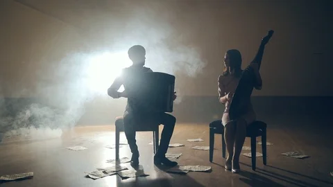 Musicians silhouettes playing and falling sheets, smoke on background in slowmo Stock Footage 106699642