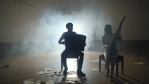Musicians silhouettes playing and falling sheets, smoke on background in slowmo Stock Footage 106702815