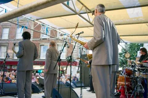 Musicians on stage viewed from behind the stage. Stock Photos