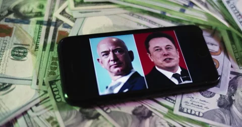 Musk Vs Bezos Image on iphone surrounded by $100 Bills. Stock Footage 169006695
