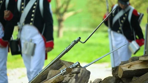 Muskets lying on pieces of wood while French Napoleon soldiers taking the Stock Footage 130091914