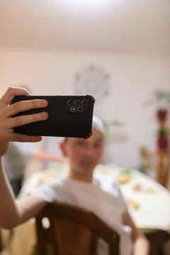 A Muslim boy taking a selfie while having an iftar during Ramadan Stock Photos
