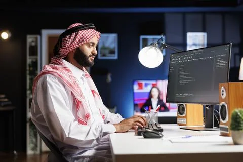 Muslim developer writes code on computer Stock Photos