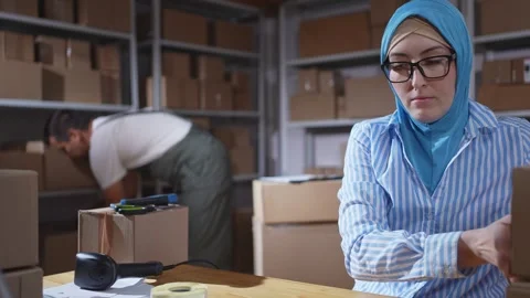 Muslim female hijab worker Using Barcode Scanners close up Video stock 288993511
