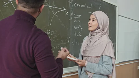 Muslim Female Student Solving Geometry Problem at Blackboard Stock Footage 155748020