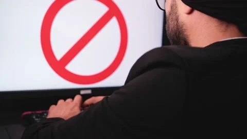Muslim hacker man typing on the keyboard is getting banned on the social media Stock Footage 159150592
